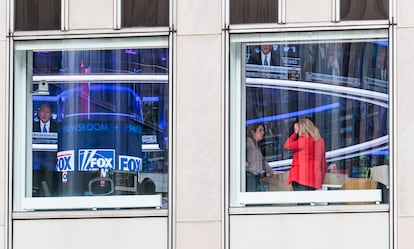 Two women inside the headquarters of the Fox network in New York, on Wednesday, April 19.