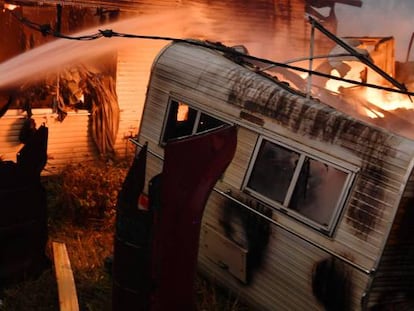 Bomberos del cuerpo de forestales extinguen un fuego en una propiedad, en Moruya, Australia. 