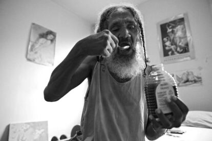 BALTIMORE, MD - SEPTEMBER 07: Keith Boissiere eats honey before a run on September 7, 2016 in Baltimore, Maryland. The 'Running Man' says multiple spoonfuls of the nectar makes him feel full so that he can run without eating a heavy breakfast. Keith Boissiere has been running nearly every day for the past three decades - averaging more than 20 miles per day - for his health. Many residents only know the enigmatic figure by his nickname of the 'Running Man' - but Boissiere, 64, is a green-card-carrying Trinidad and Tobago native living in solitude on the border of Harlem Park and Sandtown-Winchester: two menacing neighborhoods in Baltimore City. Having never competed, nor having a desire to do so, the 'Running Man' held a daily streak of 12 and a half years which helped him earn his alias. But his health took a turn for the worse in 2008 - the streak ended - as his life almost did, too. Through all of his troubles, which includes being on a kidney donor recipient list, Boissiere copes the only way he knows how - he continues to run - as the hospital encouraged him to do in order to aid his failing health. He doesn't brag about his accomplishments or mention his celebrity-like status despite being constantly acknowledged - and these days barriers such as rain, snow and hospital appointments often dictate his running schedule. His drive and passion for his own health is often described as bringing positivity and strength to residents in the city, and the people of Baltimore still witness the 'Running Man' from West to East, and North to South, as he competes with only himself to stay upright by staying fit in a city plagued by: drugs, guns, crime, and violence.   Patrick Smith/Getty Images/AFP
== FOR NEWSPAPERS, INTERNET, TELCOS & TELEVISION USE ONLY ==