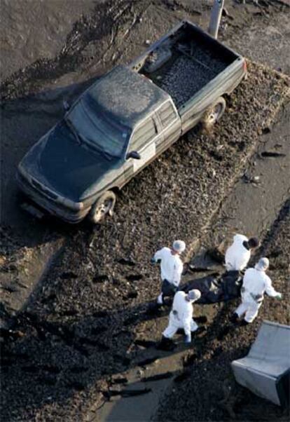 Cuatro forenses sacan un cuerpo en St. Bernard (Luisiana).