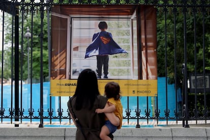 Una mujer y su hijo, frente a una cartel publicitario de PhotoEspaña, en un imagen de archivo.
