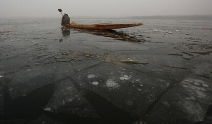 Un pescador kashmiri navega sobre un lago parcialmente helado, a las afueras de Srinagar (India).