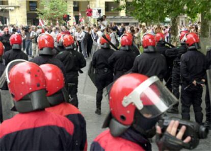 Agentes de la Ertzainzta vigilan a los manifestantes en la concentración ilegal de hoy en San Sebastián.