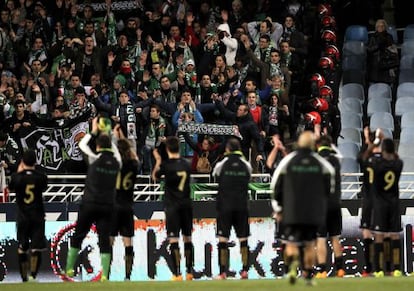 Racing players applaud their fans at the Anoeta stadium.