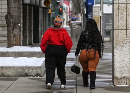 Two women walk through downtown Edmonton, Alberta, Canada.