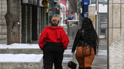 Two women walk through downtown Edmonton, Alberta, Canada.