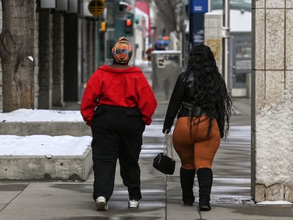 Two women walk through downtown Edmonton, Alberta, Canada.