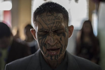 A former Mara Salvatrucha (MS-13) gang member prays.