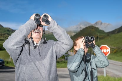 Dos turistas observan con sus prismáticos a los osos pardos de Somiedo (Asturias), el 25 de mayo.