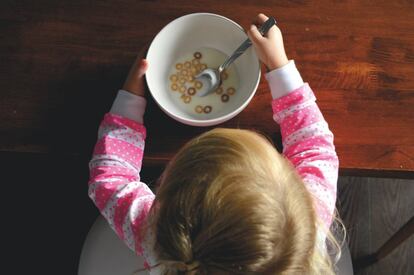 Una niña come un bol de cereales.