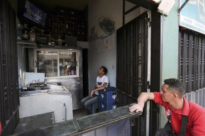 Vendedores venezolanos ven el concierto de 'Venezuela Aid Live' en una tienda de licores en San Antonio.