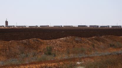 A line of trucks carrying humanitarian aid waits to receive permission from Israel to access Gaza through the Kerem Shalom crossing, next to the border with Egypt.