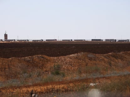 A line of trucks carrying humanitarian aid waits to receive permission from Israel to access Gaza through the Kerem Shalom crossing, next to the border with Egypt.
