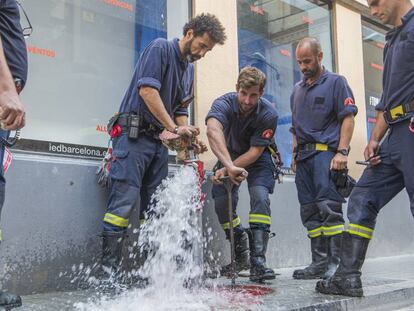 Bomberos comprueban una boca de incendios en Gracia.