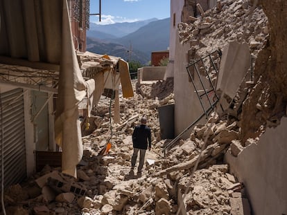 A man walks amongst the rubble of collapsed buildings following yesterday's earthquake, on September 10, 2023, in Moulay Brahim, Morocco.
