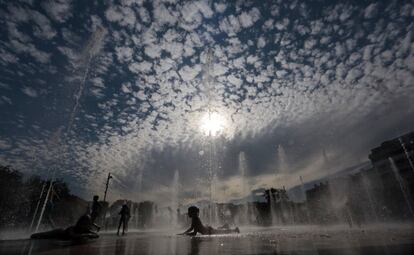 Un niño se refresca en una fuente de Niza, Francia.