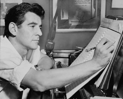 Leonard Bernstein making musical notations sitting at the piano in his New York home in 1955.