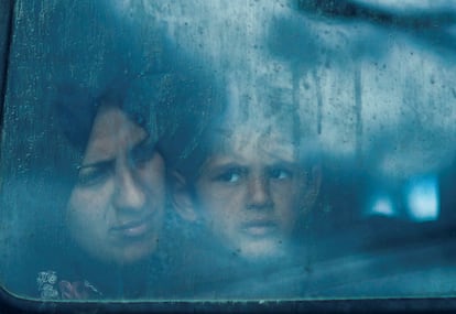 Displaced Palestinians look out from a bus window, amid the ongoing conflict between Israel and the Palestinian Islamist group Hamas, in Rafah, in the southern Gaza Strip