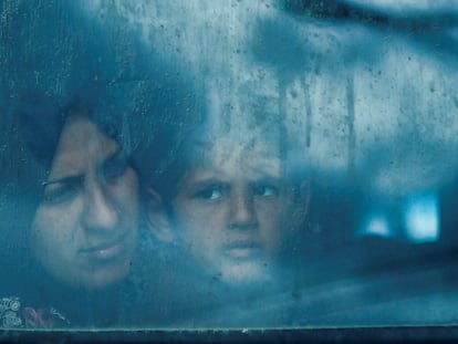 Displaced Palestinians look out from a bus window, amid the ongoing conflict between Israel and the Palestinian Islamist group Hamas, in Rafah, in the southern Gaza Strip