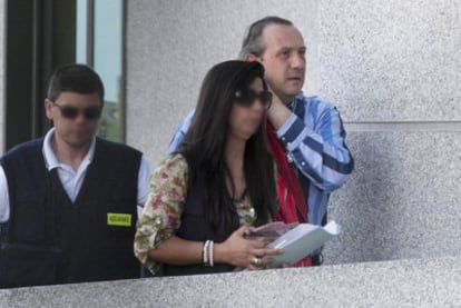 Two customs officers accompany businessman Jorge Dorribo (right) into court.