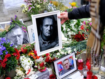 Una mujer deja un retrato del opositor ruso Alexéi Navalni este pasado domingo en un homenaje al disidente ruso en Barcelona