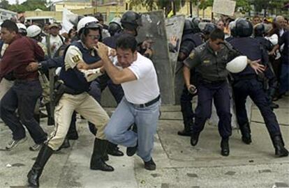 Miembros de la policía se enfrentan a los manifestantes en la puerta del tribunal.