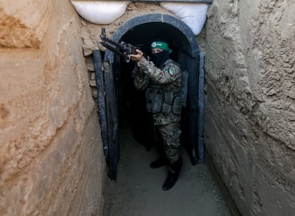 A fighter from the Izz ad-Din al-Qassam Brigades stands in front of a tunnel during an exhibition of weapons, missiles, and heavy equipment for the military wing of Hamas.