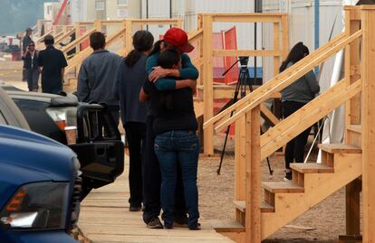 People share a moment at the Tselletkwe Lodge, a safe place for Indigenous evacuees and others who've been displaced due to the wildfires in Kamloops, B.C., Canada, August 22, 2023.