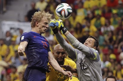 Julio Cesar tenta segurar a bola cabeceada por Dirk Kuyt.