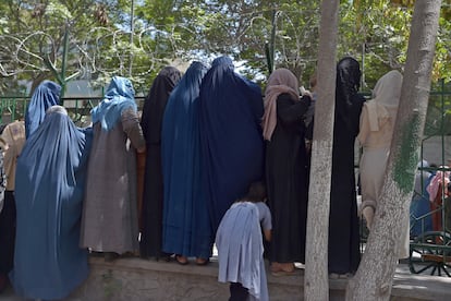 Mujeres afganas que han huido del avance de los talibanes esperan para recibir comida de beneficencia en un parque de Kabul, el viernes.