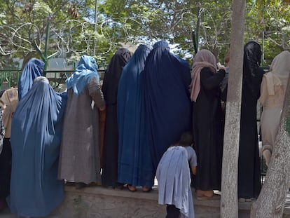 Mujeres afganas que han huido del avance de los talibanes esperan para recibir comida de beneficencia en un parque de Kabul, el viernes.