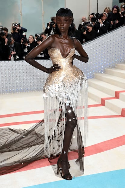 Model Anok Yai, in a golden dress with tulle and fringed beading by Prabal Gurung.