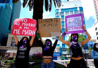 Women hold signs during a protest against femicide on the Day of the Dead celebrations in La Paz, Bolivia, November 1, 2020. The signs read: (L-R) "I don't die, they kill me", "Naked you uncomfortable, dead no" and "Today not all our voices are there, because from the grave you cannot scream." REUTERS/David Mercado