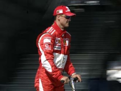Michael Schumacher pasea por el <i>paddock</i> en un patinete eléctrico.