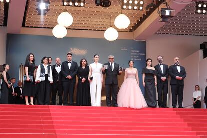 The team of 'The Seed of the Sacred Fig', on Friday afternoon at the film's gala premiere.  Mohammad Rasoulof holds photographs of the two actors, Missagh Zareh and Soheila Golestani, who have not been able to leave Iran.