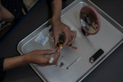 A woman prepares a dose in Tijuana, Baja California