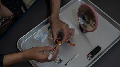 A woman prepares a dose in Tijuana, Baja California, in May 2023.