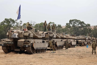 Israeli soldiers positioned with Merkava tanks near the border with the Gaza strip in southern Israel on October 9, 2023.