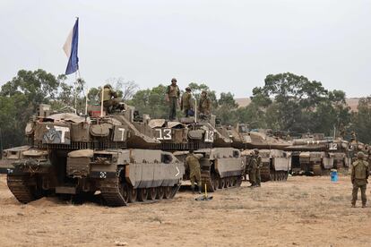 Israeli soldiers positioned with Merkava tanks near the border with the Gaza strip in southern Israel on October 9, 2023.