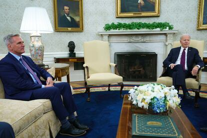 Speaker of the House Kevin McCarthy of Calif., left, listens to President Joe Biden