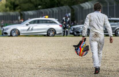 Alonso se aleja de la pista tras el accidente en Melbourne.