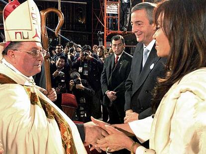 El obispo Juan Carlos Maccarone saluda a Cristina Kirchner en presencia de su esposo en mayo pasado.