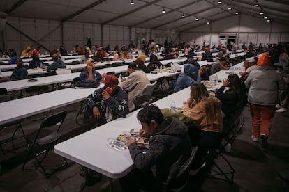 Migrants eat at the Randall's Island shelter in April.