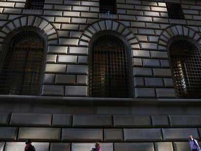 People walk by the Federal Reserve Bank of New York in the financial district of New York City, U.S., June 14, 2023.