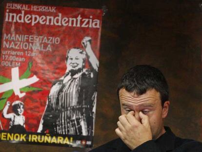 El secretario general de ANV, Antxón Gómez, con el cartel de la manifestación, en una rueda de prensa.