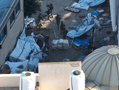 Israeli soldiers walk through the Al Shifa hospital complex on Wednesday during what they say is a delivery of humanitarian aid to the facility. Reuters has not been able to verify the date of the image.