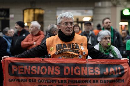 Decenas de personas, entre ellas, miembros de la Plataforma de afectados por las hipotecas (PAH) y Marea Pensionista protestan junto la sede de Junts tras el voto en contra al decreto ómnibus del Gobierno, el 23 de enero.