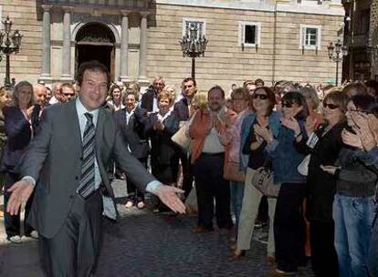 Jordi Hereu, ayer, en el pasillo de entrada que le hicieron funcionarios del Ayuntamiento de Barcelona.