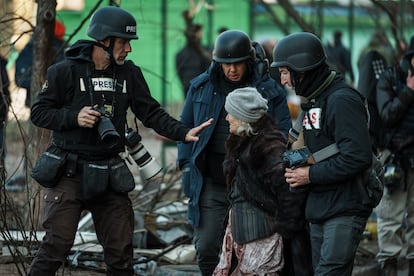 Varios periodistas hablan con una mujer, unos días después de la invasión rusa de Ucrania, en 2022.