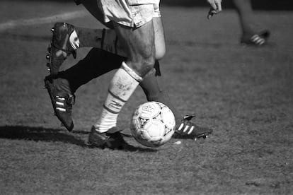 Dos jugadores persiguen el balón en un partido de fútbol entre el Rayo Vallecano y el Real Zaragoza.